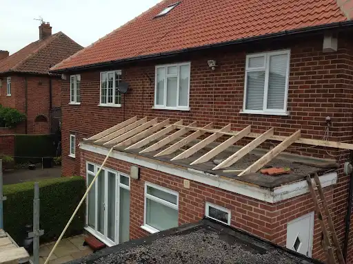 Stage 2 (Progress): Structural timber rafters engineered to create high-pitch roof profile