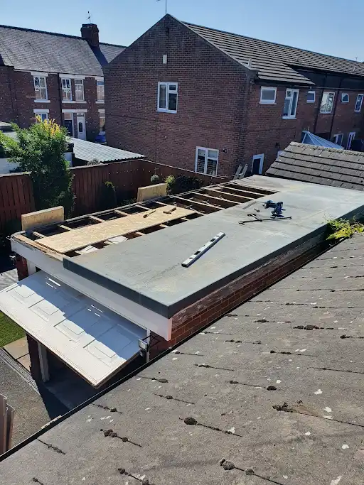 Stage 1 (Before): Existing roofing entirely stripped away, high-durability watertight EPDM rubber garage roofing being installed