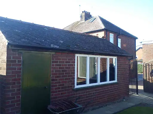 Stage 1 (Before): Heavily weathered, moss-covered crumbling tile outbuilding roof