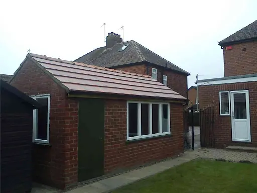 Stage 2 (After): Outbuilding completely restored with clean modern interlocking tiling