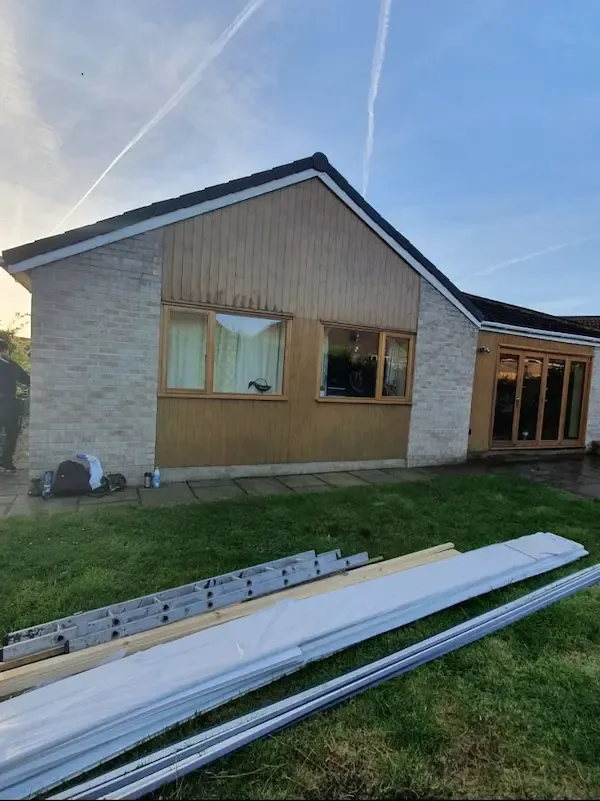 Bungalow with weathered timber cladding before work