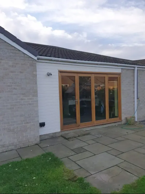 White UPVC cladding around new bifold doors