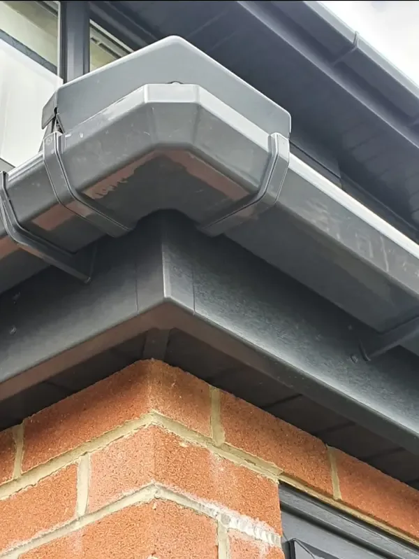 Close-up of anthracite gutter corner and fascia