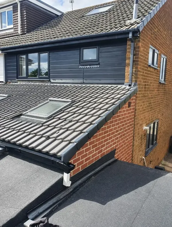 Anthracite cladding, fascias and gutters on a rear extension and dormer