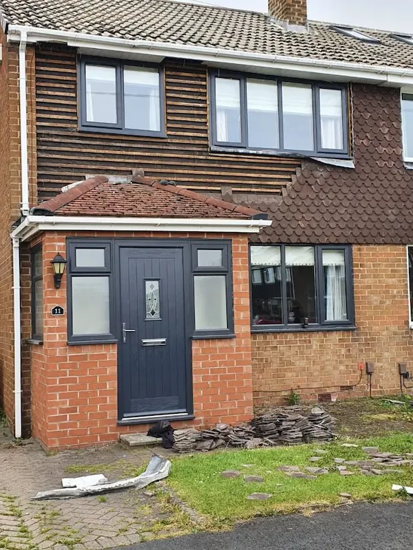 Semi-detached house with an old porch roof and worn timber boarding