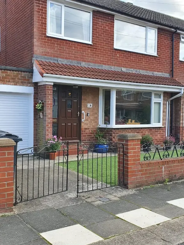 Red tiled canopy over a porch and bay window