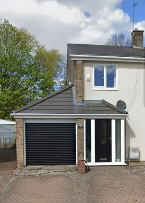 Garage and front porch converted to a slate-grey tiled pitched roof